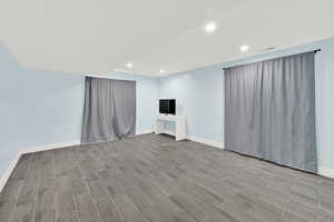 Unfurnished living room with wood finish floors and recessed lighting