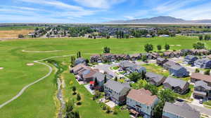 Aerial view of a golf club and a mountain backdrop