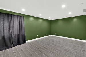 Spare room with wood tiled floors and recessed lighting