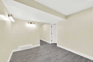 Empty room featuring baseboards and wood finish floors