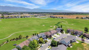 Aerial perspective of suburban area featuring mountains and a local golf course