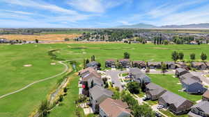 Aerial perspective of suburban area with a local golf course and a mountainous background