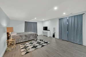 Bedroom with wood finish floors and recessed lighting