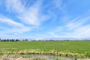 View of mountain background with a nearby body of water and rural landscape