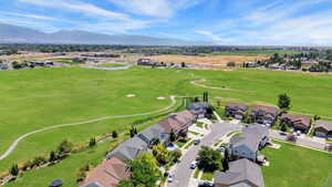 Aerial perspective of suburban area with mountains and a golf club