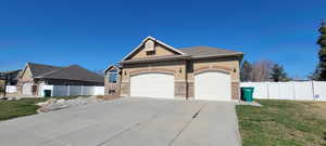 View of front of house featuring an attached garage, stucco siding, and concrete driveway