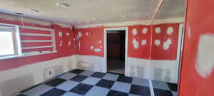 Empty room featuring a textured ceiling