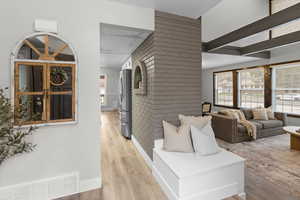 Hallway featuring light wood-style flooring and baseboards