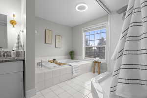 Full bath with a bath, light tile patterned floors, a shower with curtain, and vanity