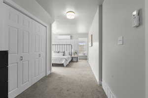 Bedroom featuring light carpet, a closet, and a textured ceiling