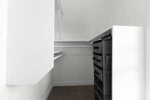 Walk in closet with dark carpet