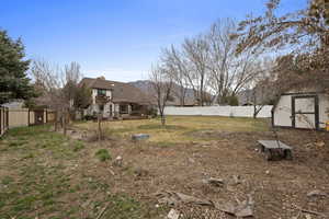 Fenced backyard with a storage shed
