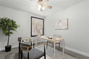 Office area with light colored carpet and ceiling fan
