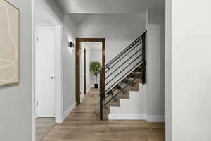 Foyer with light wood-type flooring and stairway