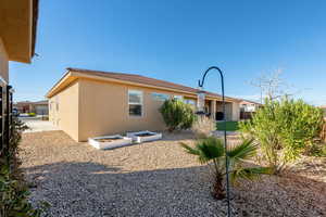 Back of house featuring stucco siding