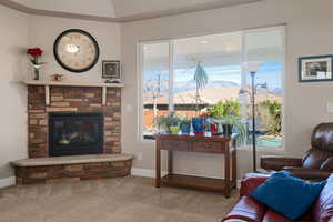 Living area featuring carpet and a fireplace