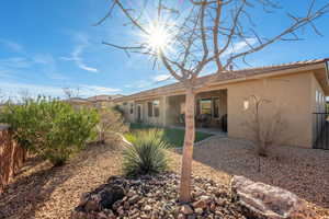 Back of house with a patio, stucco siding, and a fenced backyard