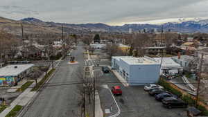 View of asphalt street with a mountain view, sidewalks, and curbs