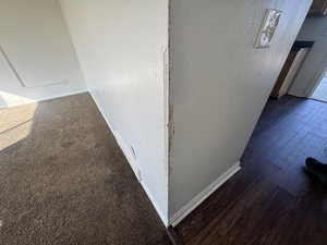 Detailed view of baseboards and a textured wall