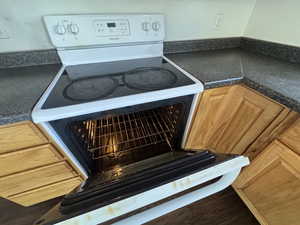 Kitchen view of dark countertops and electric stove
