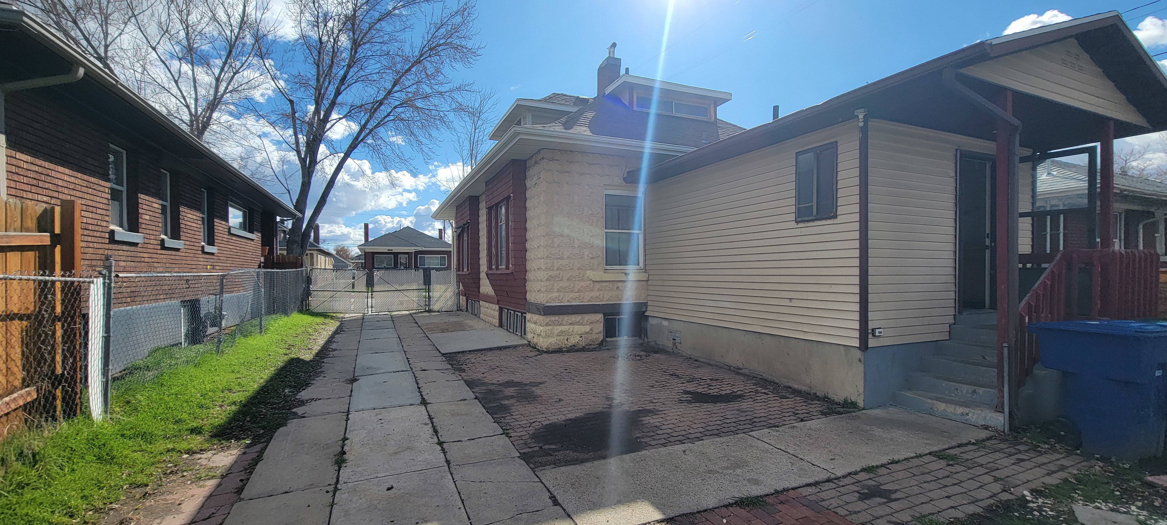 View of home's exterior with a gate and a patio