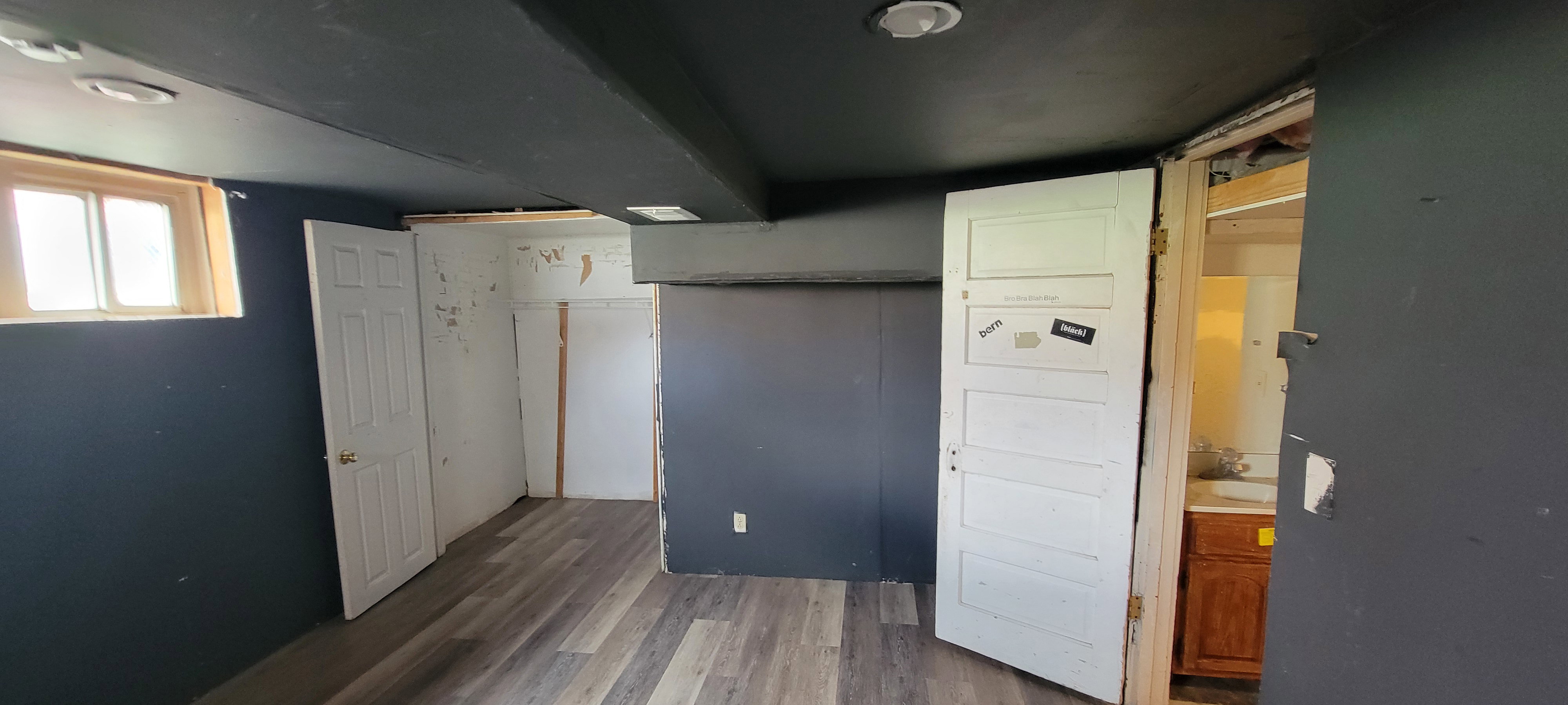 Unfurnished bedroom with dark wood-style floors