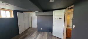 Unfurnished bedroom with dark wood-style floors