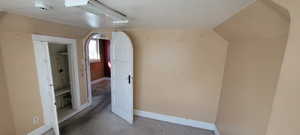Bonus room featuring baseboards and carpet floors