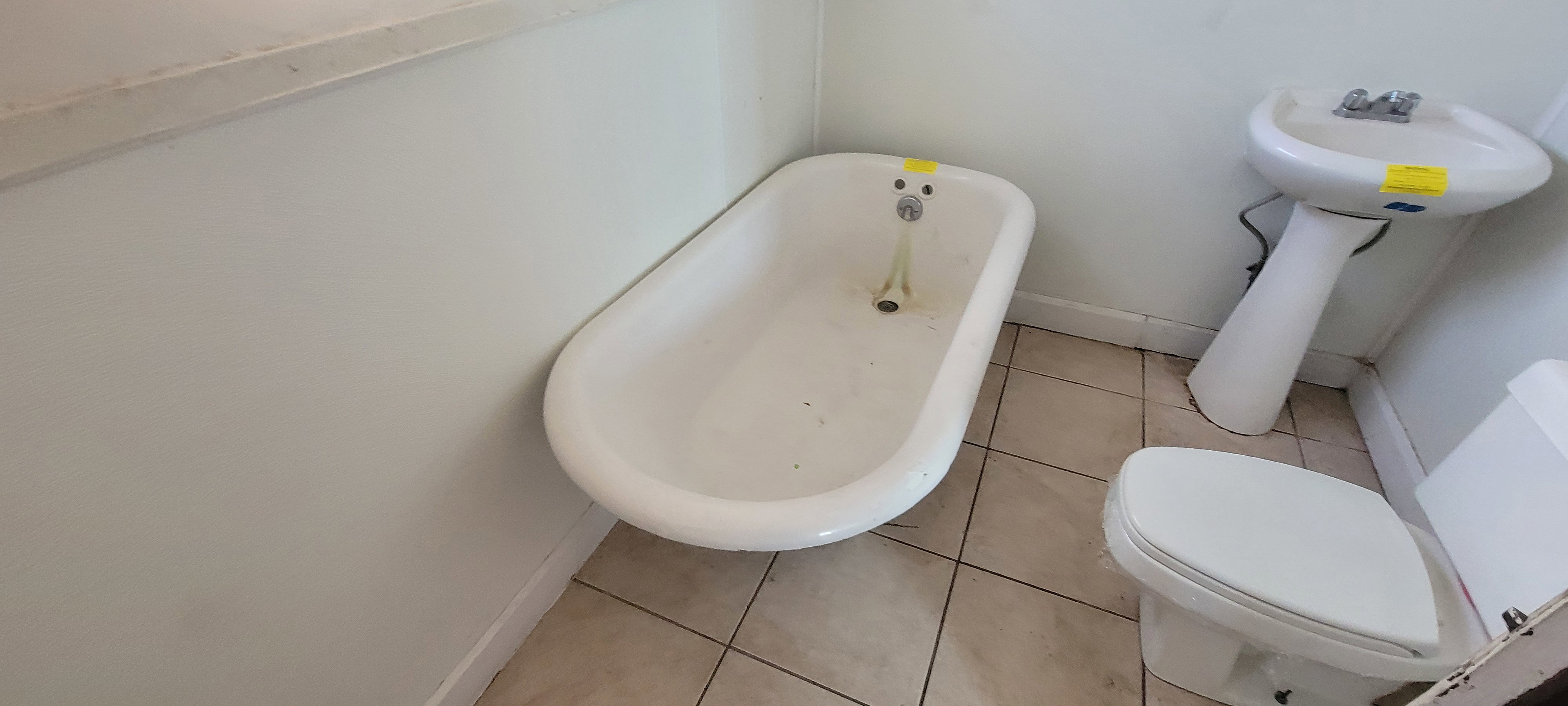 Bathroom featuring a freestanding bath and light tile patterned flooring