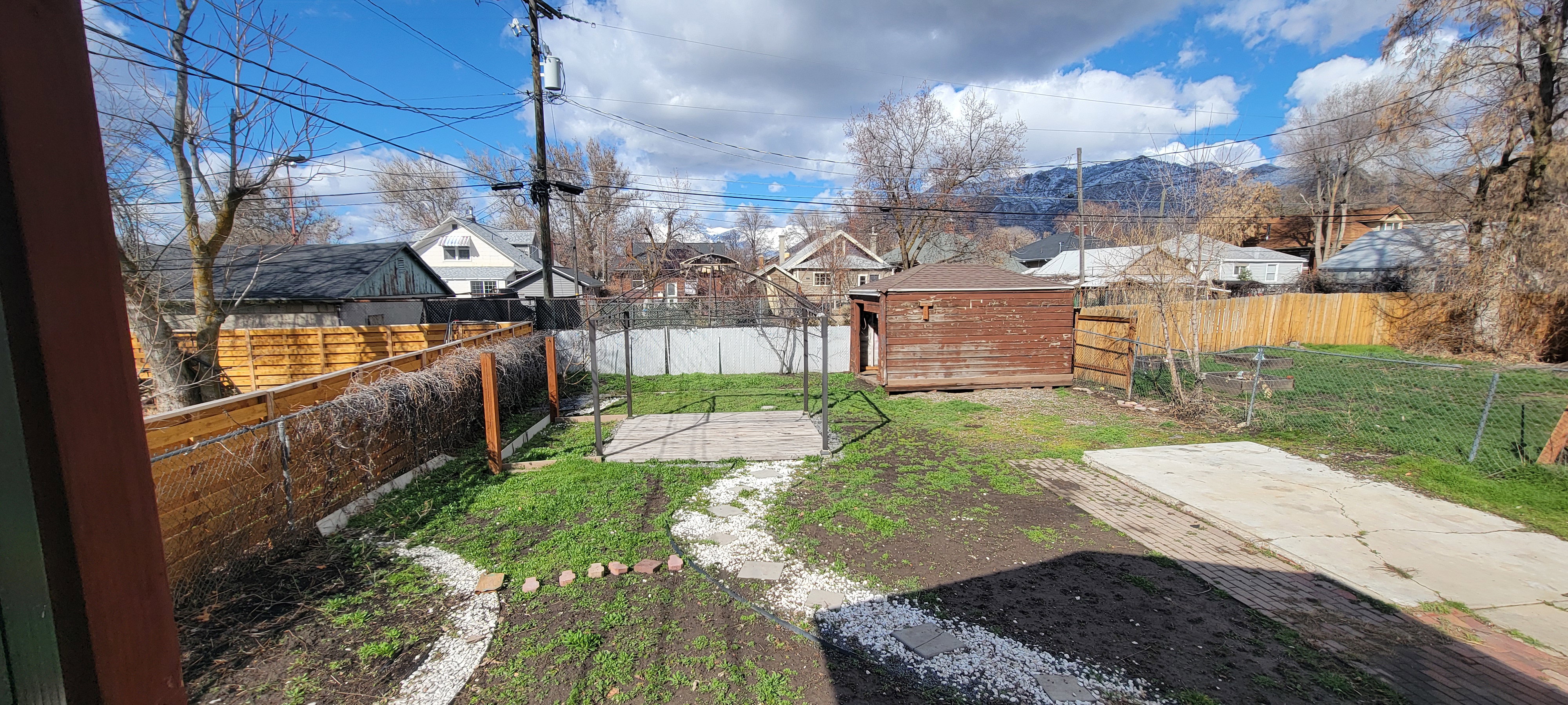 Fenced backyard featuring a residential view and a patio area