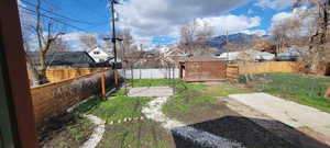 Fenced backyard featuring a residential view and a patio area