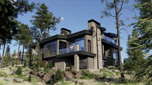 Rear view of house with a balcony and stone siding