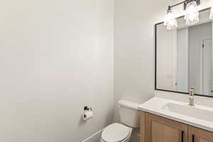 Half bath featuring vanity and toilet