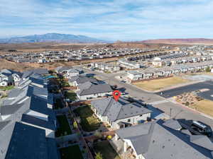 Aerial perspective of suburban area with a mountainous background