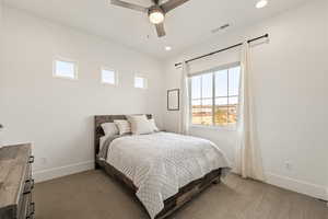Bedroom featuring multiple windows, dark colored carpet, ceiling fan, and recessed lighting