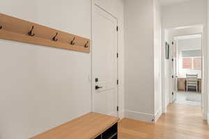 Mudroom featuring light wood-type flooring and baseboards