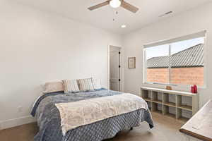 Bedroom featuring light colored carpet, a ceiling fan, and recessed lighting