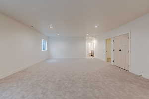 Unfurnished room with light carpet and recessed lighting