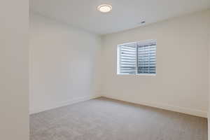 Unfurnished room with light carpet and baseboards