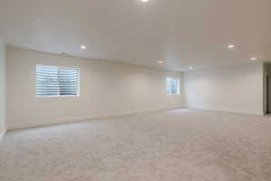 Empty room featuring light carpet and recessed lighting
