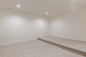 Empty room featuring carpet flooring and recessed lighting