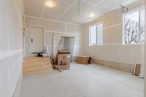 Unfurnished bedroom featuring concrete flooring