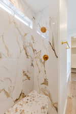 Bathroom featuring a marble finish shower