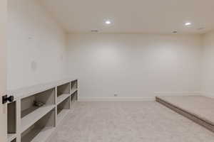 Empty room featuring light carpet and recessed lighting