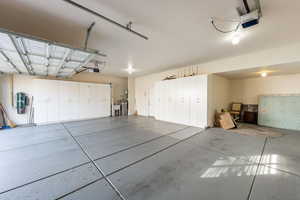 Garage featuring a garage door opener and a central vacuum unit