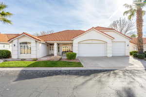Mediterranean / spanish-style house featuring stucco siding, an attached garage, a tiled roof, driveway, and a porch