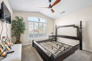 Bedroom with light colored carpet and a ceiling fan