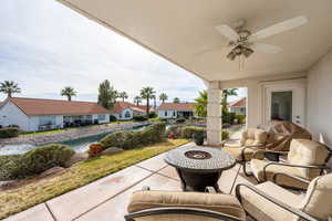 View of patio / terrace with a ceiling fan, a residential view, and an outdoor living space with a fire pit