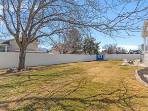 Fully-fenced backyard featuring a patio area
