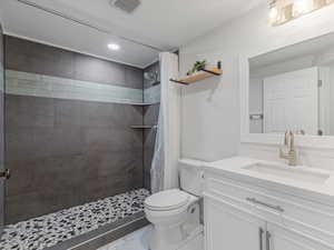 Bathroom with vanity, a stall shower, marble finish flooring, and recessed lighting